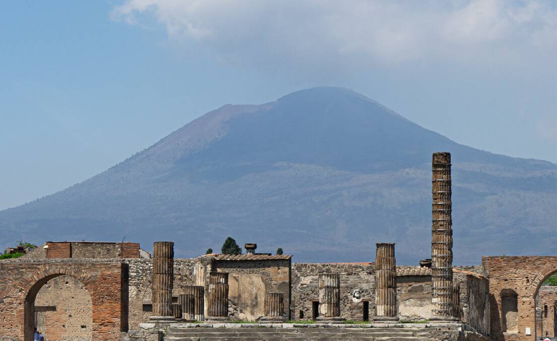The volcano of Mount Vesuvius looms over the remains of the ancient city of Pompeii.