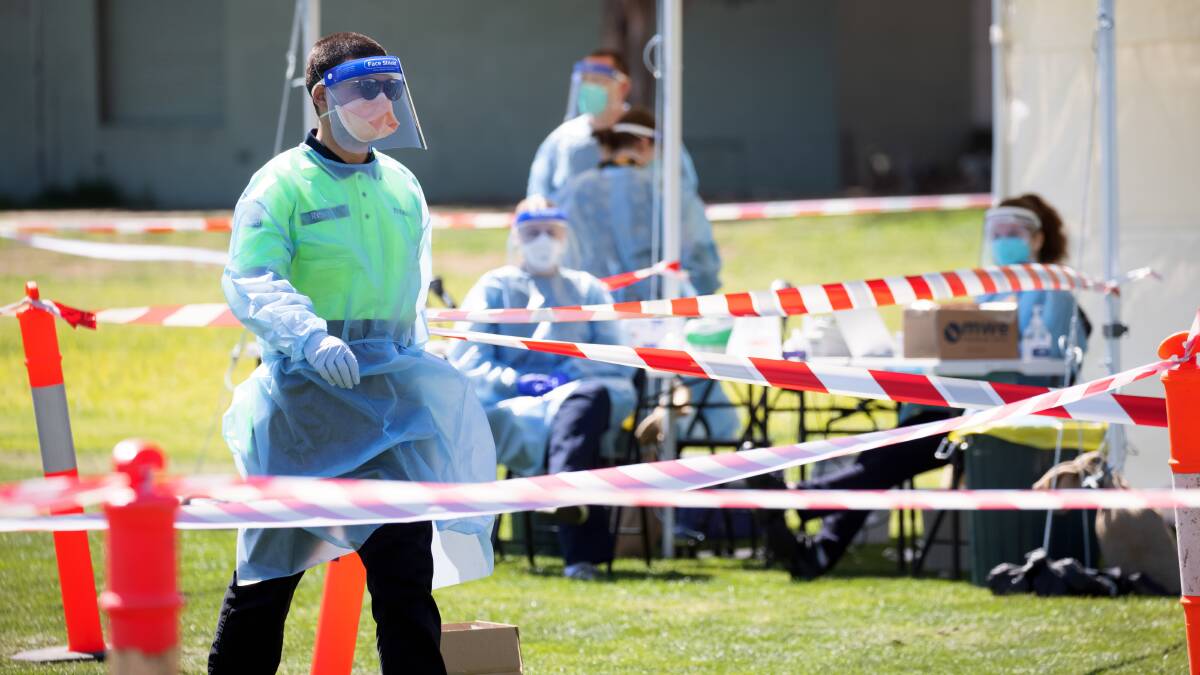 Staff set up the pop-up clinic at the Watson oval. Picture: Sitthixay Ditthavong