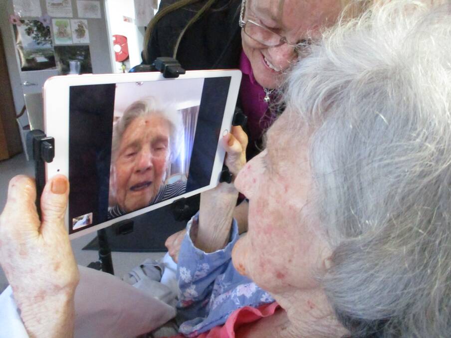 TOGETHER AT LAST: Uniting McKay House resident Betty Burgess reunited with her sister Conny (pictured on the screen) on FaceTime. Photo: Supplied