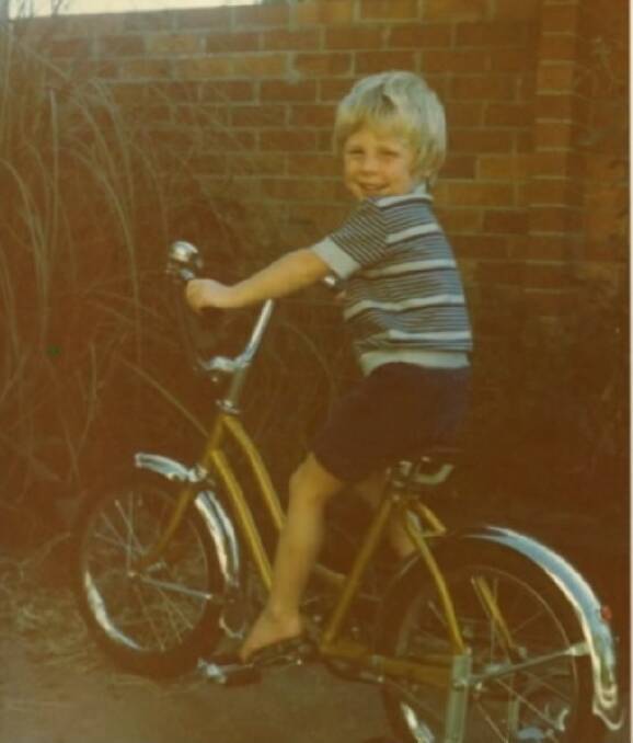Josh Langley as a child with his first bike. Photo is supplied.