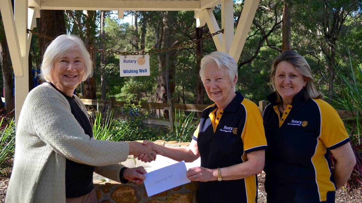 Outgoing President of Margaret River Rotary, Maxine Patmore hands cheque to Lyn Serventy, Chair of Clean Community Energy while incoming MR Rotary President looks on. Photo is supplied.