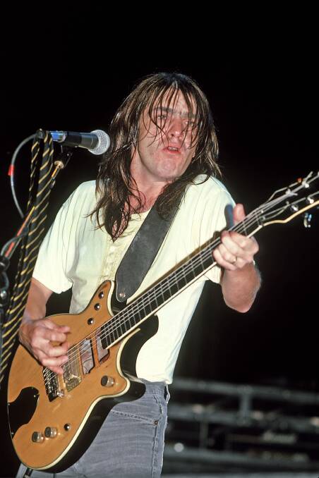 Malcolm Young was content to let brother Angus take the spotlight onstage.