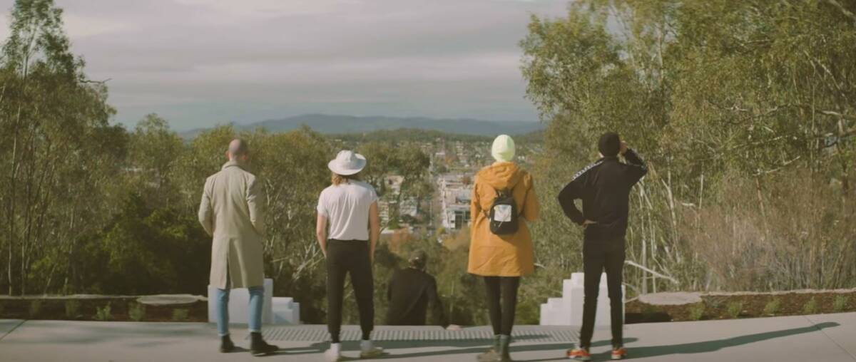 UP THE HILL: The band at the top of Monument Hill in Albury during their film clip. Picture: SCREENSHOT