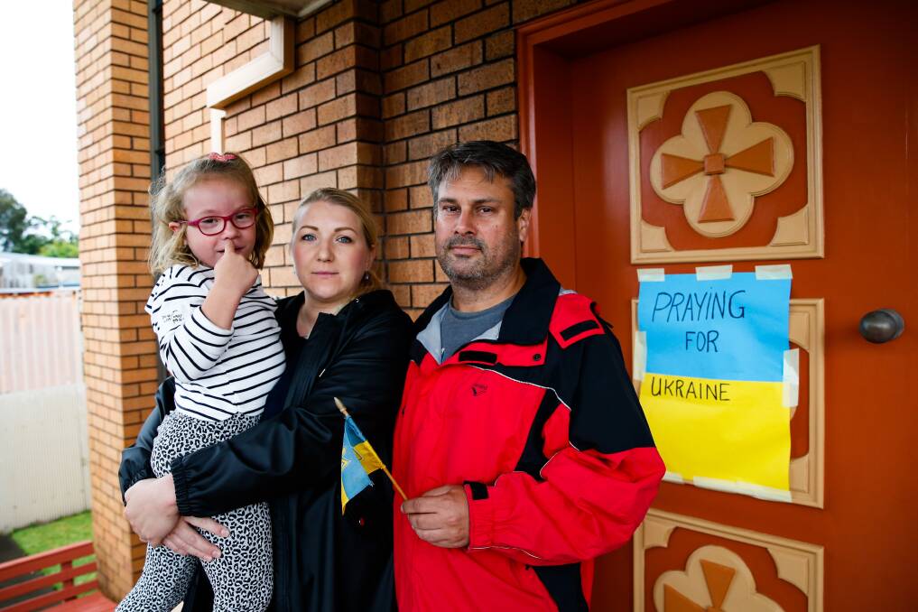 Yuliya and Andrew Malcolm with their daughter Carolina outside St Vlodymyr's Church on Saturday. Picture: Anna Warr.