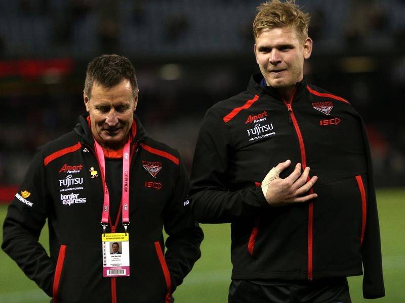 Essendon coach John Worsfold (L) has confirmed Michael Hurley (R) has injured his AC joint.