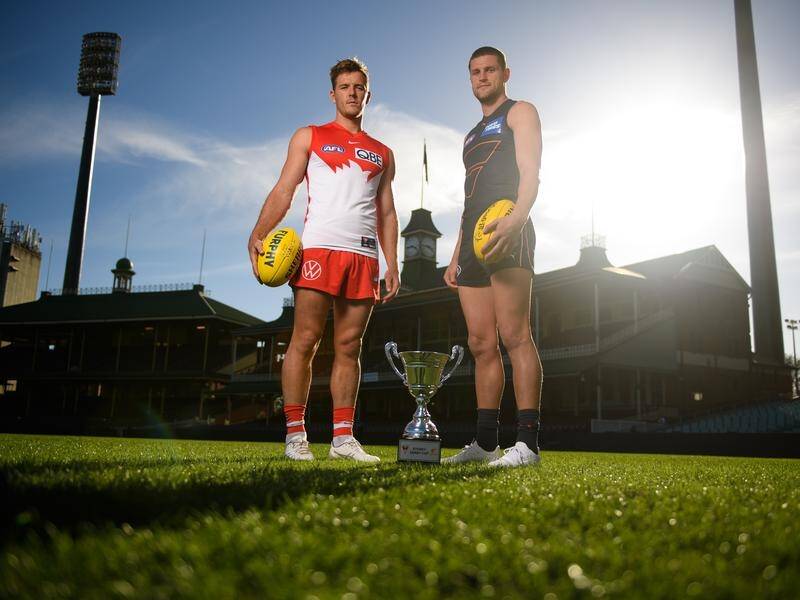 Luke Parker of the Swans and Jacob Hopper of the Giants pose ahead of their AFL clash on Saturday.