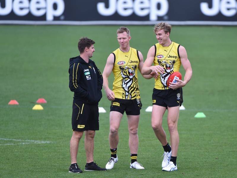 Jack Riewoldt (centre) and Tom Lynch (right) ready to rip in for Richmond.