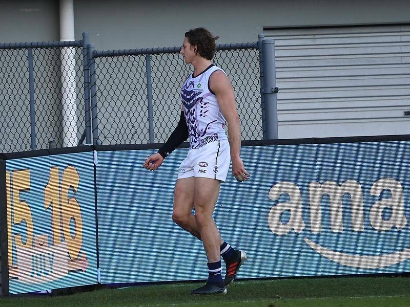 Nat Fyfe needed treatment on a shoulder injury after copping a heavy knock against Hawthorn.