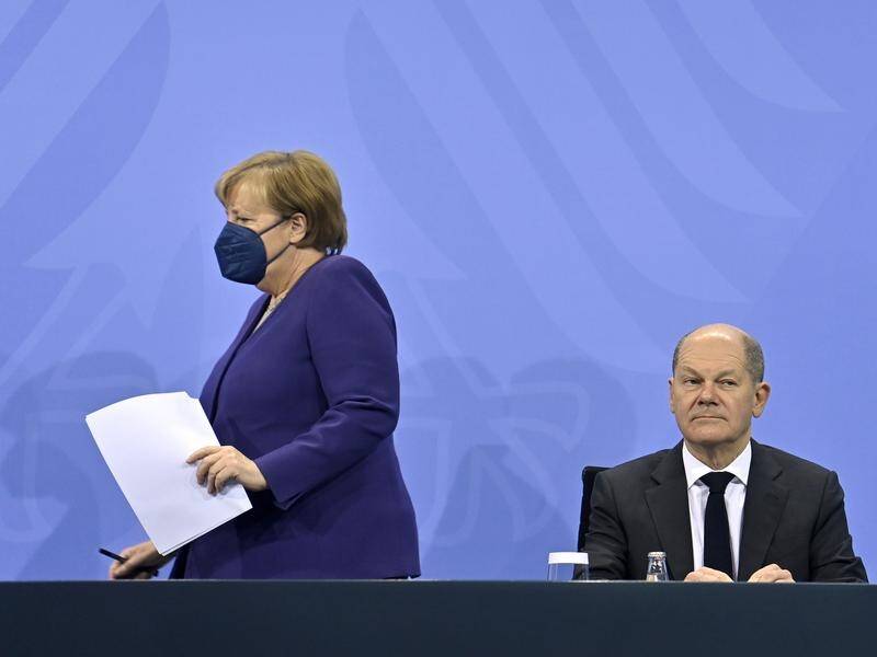 German Chancellor Angela Merkel (left) says MPs will vote on mandatory vaccines in February.