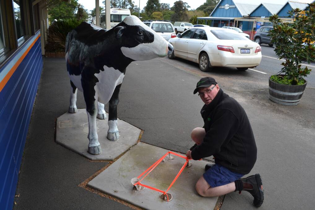 Gone: Gary Miller, from Cowaramup Agencies, helps make the exposed steel fixings a little safer for pedestrians.