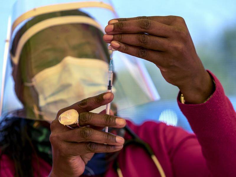 A South African health worker prepares a dose of the Pfizer coronavirus vaccine.