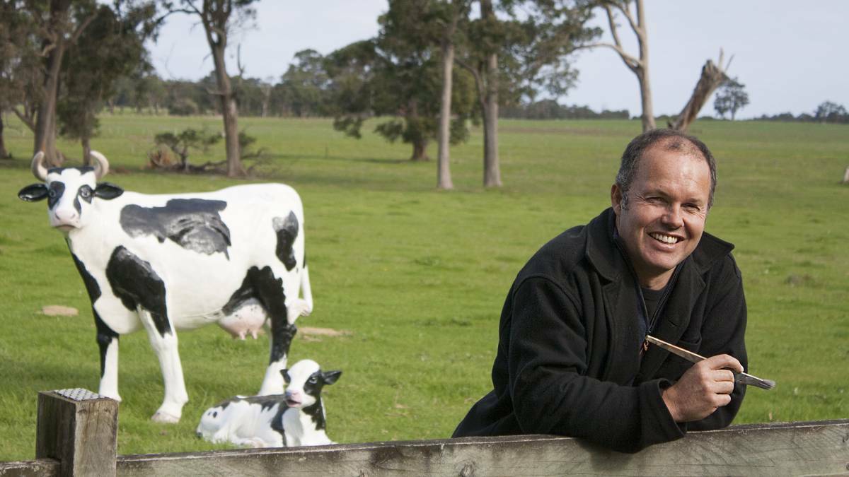 Fresh paint: Kerry Sibly finishes painting the big Cowaramup Cow for the auction.