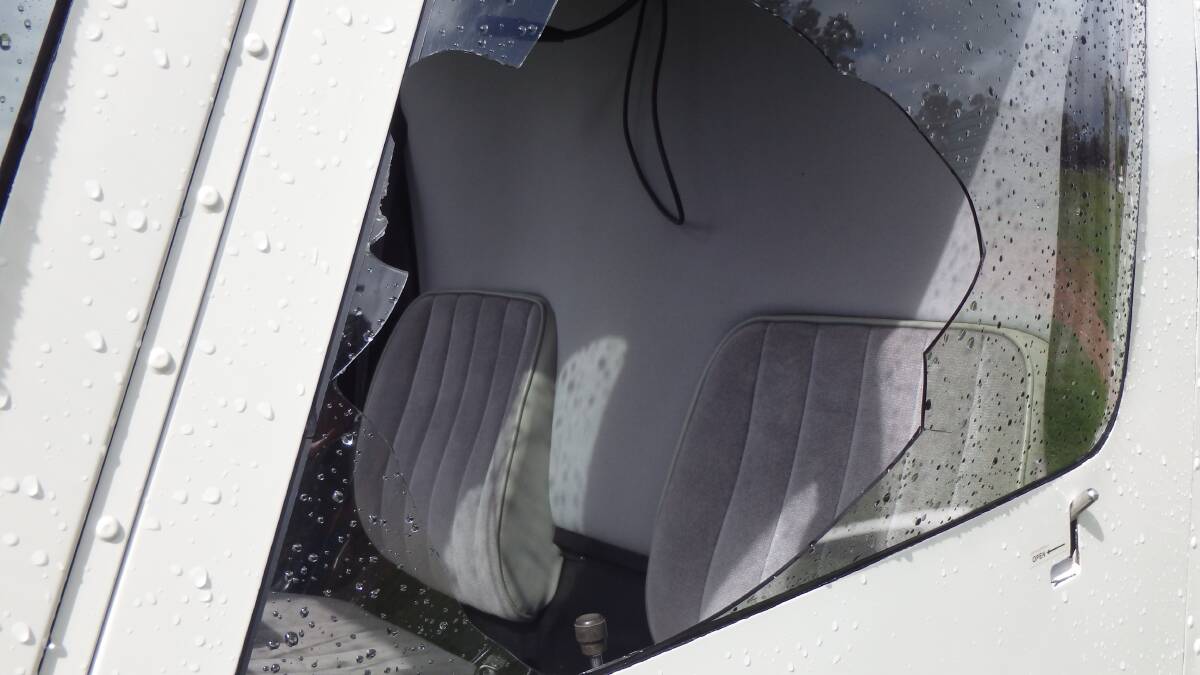 A police photograph shows the extent of damage to the helicopter's rear door.