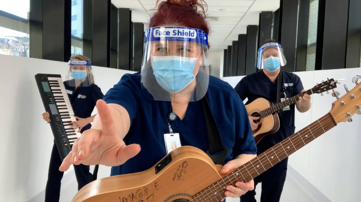 Royal Melbourne Hospitals head of music therapy Dr Emma OBrien, centre, performs with other members of the hospitals Scrub Choir. Picture: Supplied