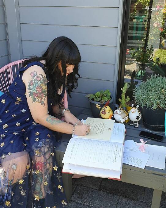 Suzanne Lewin signs the registry after her wedding this weekend. Photos: Supplied