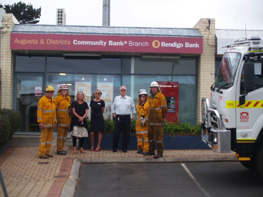 Bendigo Bank representatives and Kudardup firefighters at the Augusta branch of the community bank. Photo supplied.