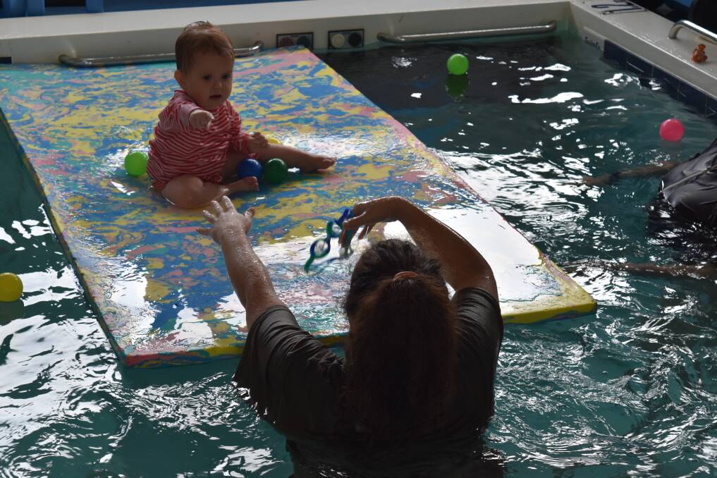 Baby Ivy gets to grips with the flotation mat with the help of mum Rebecca Simmonds. 
