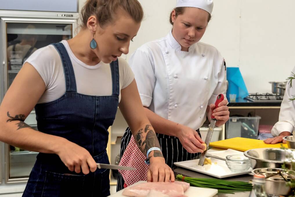 Chef Jo Barrett watched by first year apprentice Cara Viljoen who volunteered at the event for the first time in 2018. Photo. Fran Jackson