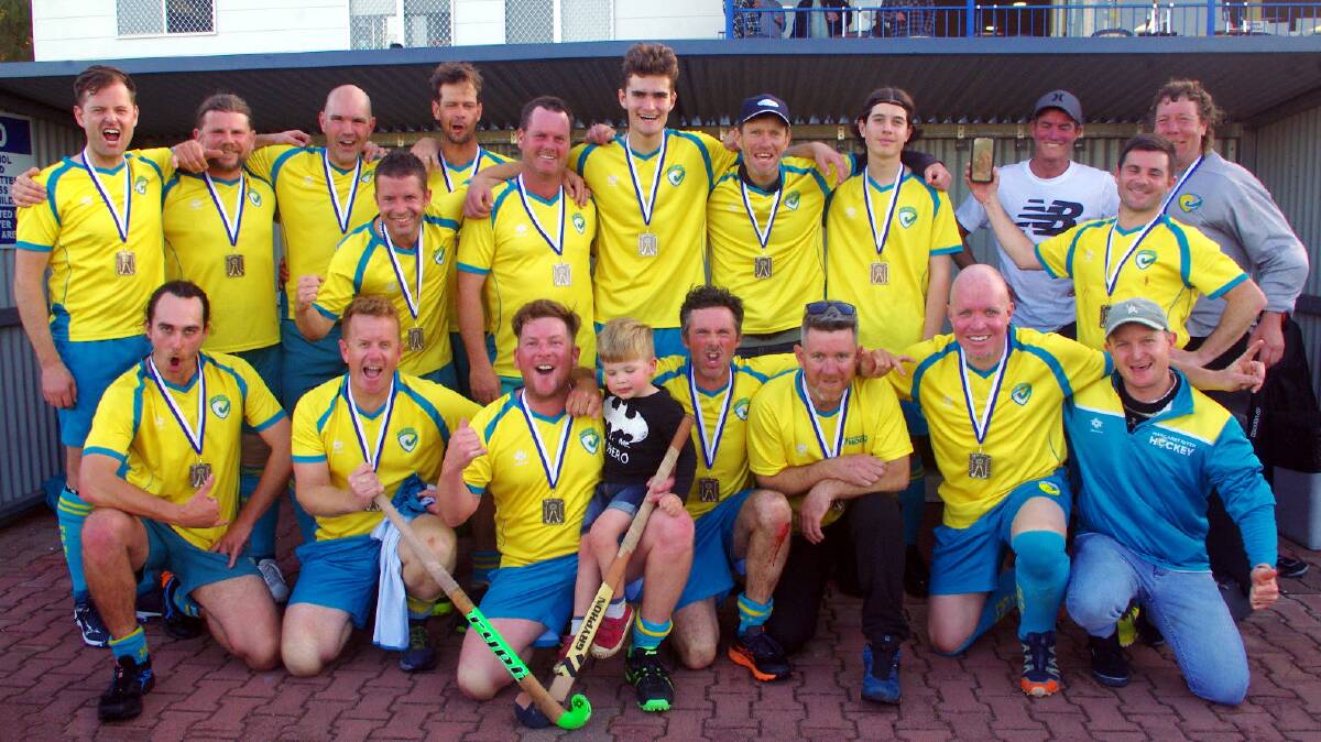 Matt Bycroft with Vance and the Margaret River Hockey Club men's team celebrating as 2022 Grand Final Winners. Picture via MR Hockey Club.