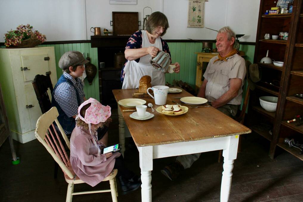 Back to the future: Margaret River & District Historical Society volunteers John Alferink and Elwyn Franklin relive life at a group home at the Old Settlement. Evan Favazzo and Ariana Williams are among children looking forward to the Open Day’s
fun and games.