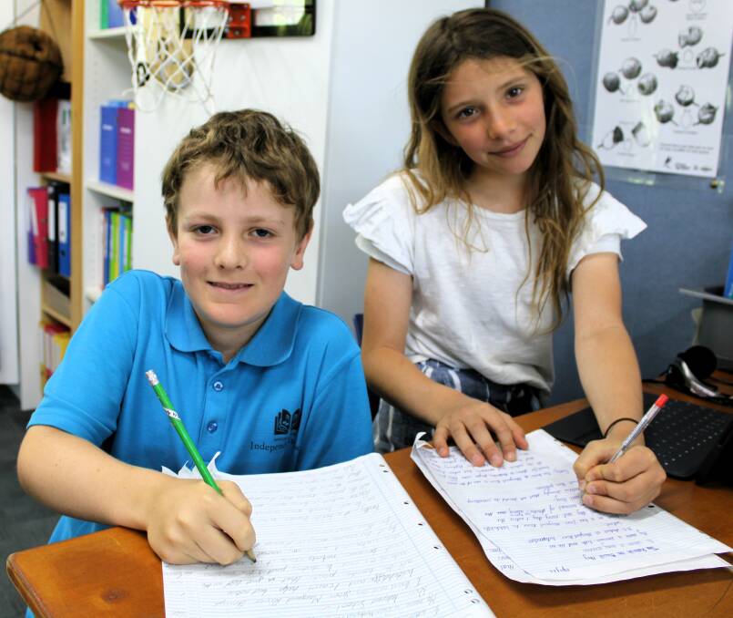 Year 5 students from Margaret River Independent School, Oscar Hardy and Leeuwin Firth, busy writing letters to the AMR Shire asking for action to be taken on local issues. Picture supplied. 