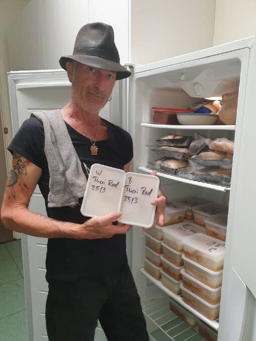 We will always be here: Dave Seegar stocks the freezer at the Community Centre, where the Emergency Relief service continues to support locals in need. Photo: Supplied