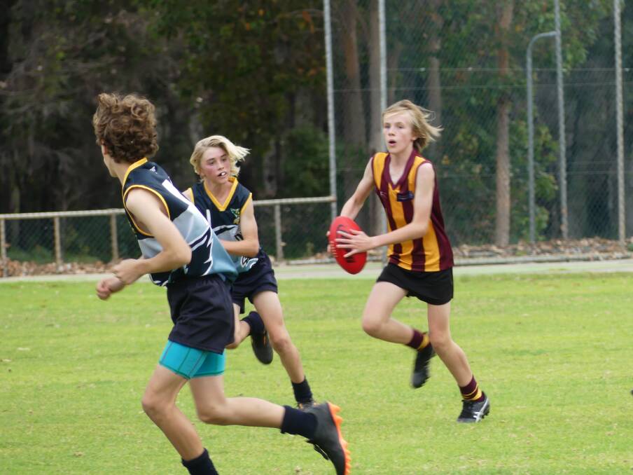Jake Miller sweeps the ball out of defence for Cowaramup Bulls Gold during the 13s game versus Hawks Navy at Augusta on Saturday morning.