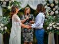 Celebrant Michelle Dobbs (centre) says registry weddings are becoming more popular as couples opt for simple, fuss-free ways to tie the knot. Pictures supplied. 