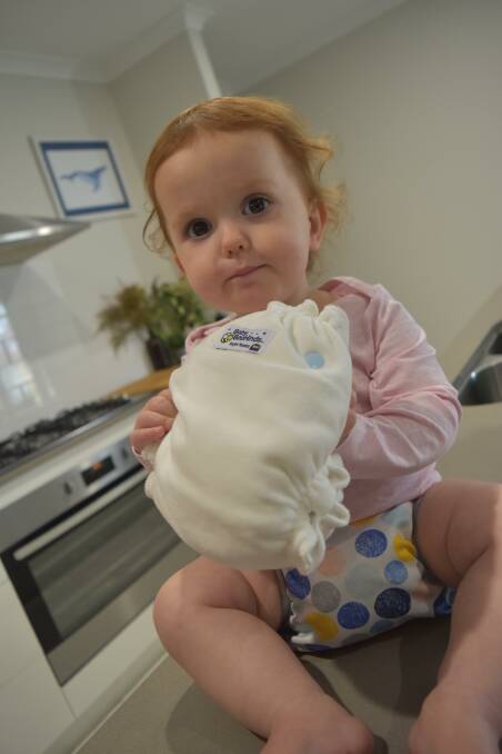 Ivy Stephens checks out one of the new style cloth nappies. 