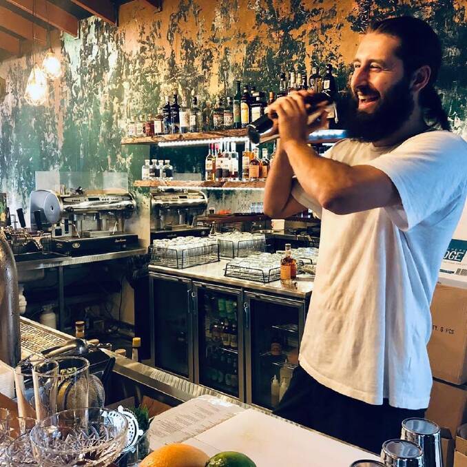 Grinnin' for gin: Arc of Iris bar manager Max Malcolm whips up some cocktails at the new look restaurant and lounge bar. Photos: Supplied