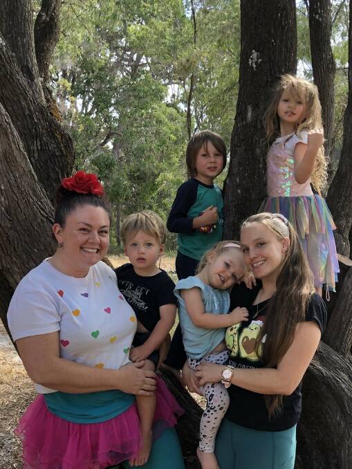Previous Blue-Belles owner Belinda Robinson (left) with new owner and educator Carissa Calton (right) and some of the nature-based family daycare's children. 