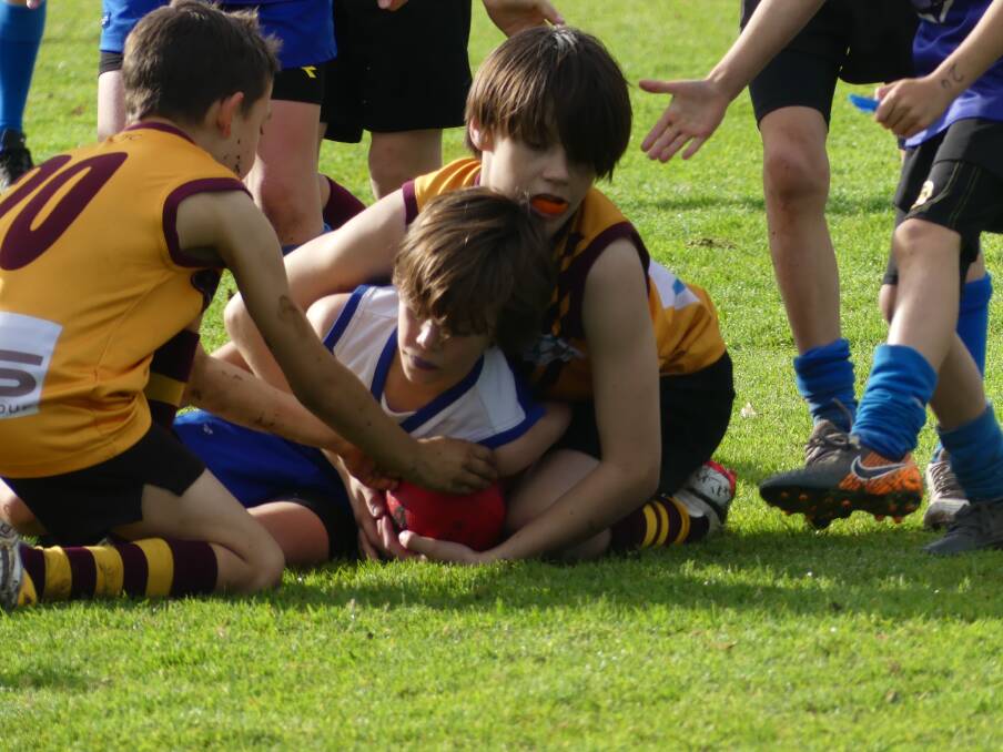Cavan Payne and Rocco Holt lay a tackle for Bulls Gold in the U9 game against Sharks. Photos Supplied