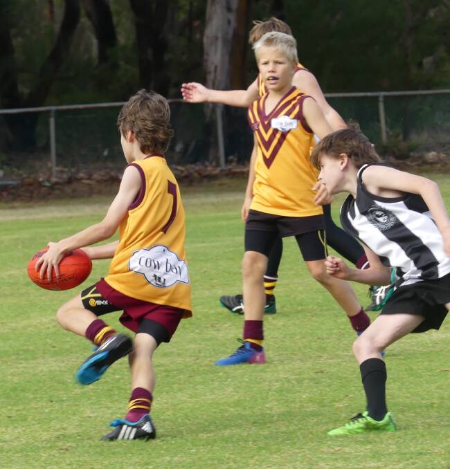 Bulls Gold U11 player, Kian Monaghan-Hall breaks away from his Augusta Magpies opponent on his way to set up a goal for Bulls. Avion Packer is ready to lend support.
