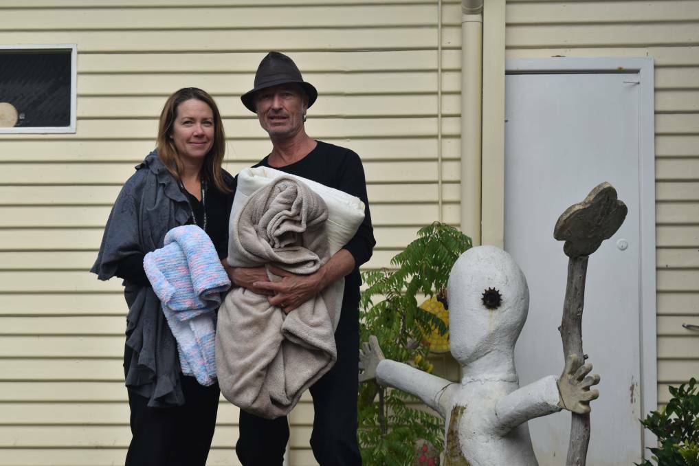 Margaret River Community Centre's Alison McKenzie and Dave Seegar of the Soup Kitchen with blankets donated during the MRCC's winter warmer drive. 