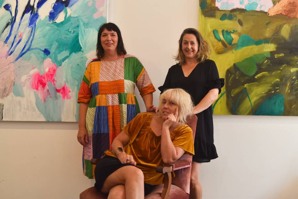 Debbo with Margaret River Gallery's Salli Coppin (seated), Elizabeth Whiteman and two of the works on display as part of the show. 