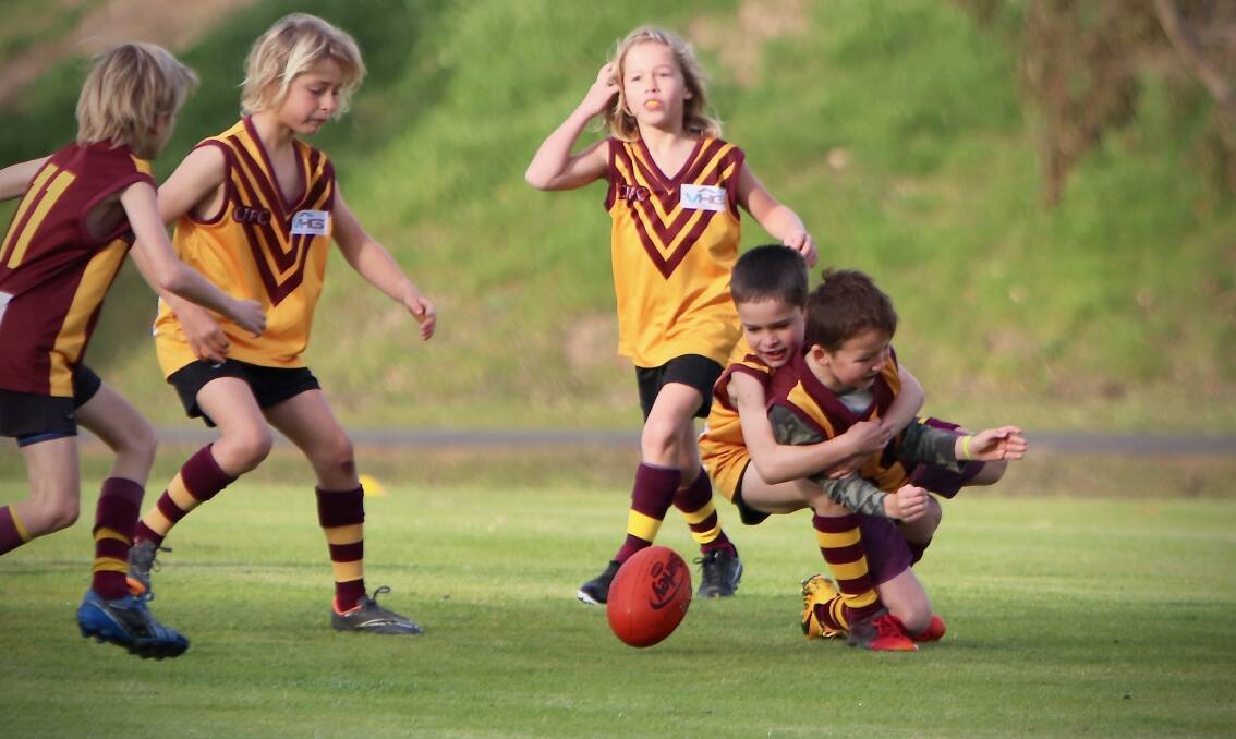 Action from the 9s game between Bulls Gold and Bulls Red at Cowaramup Oval on Saturday.