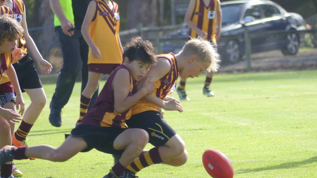 Anaru Day for Bulls Red lays a strong tackle on Avion Packer in the Cowaramup Bulls 11s derby on Saturday. 