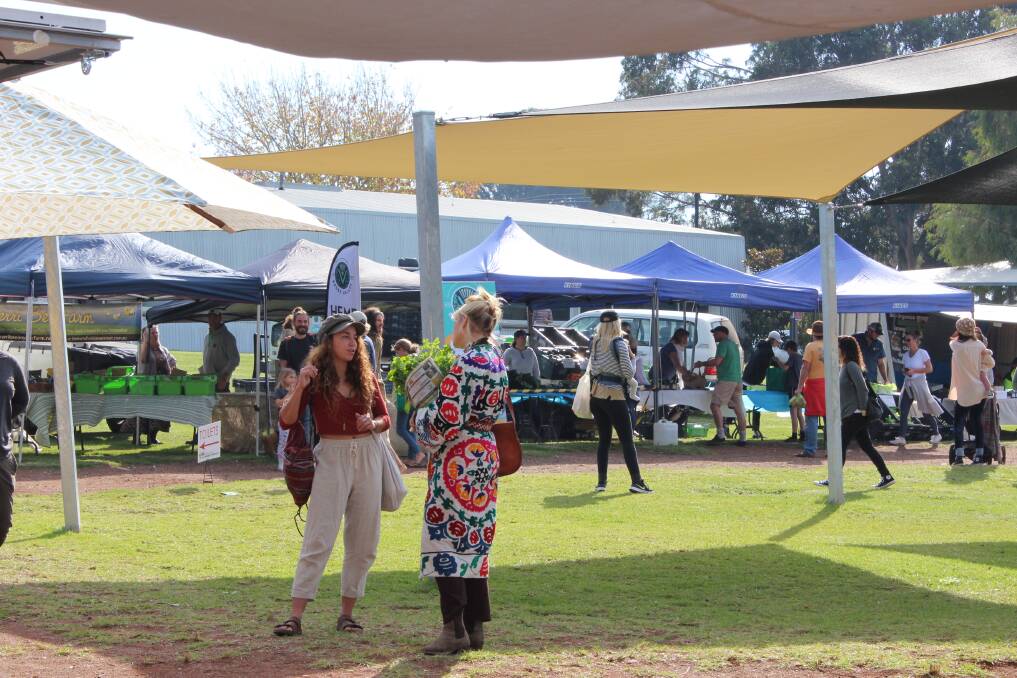 Shoppers at the Margaret River Farmers Market keep a safe distance while picking up their weekly supplies. 