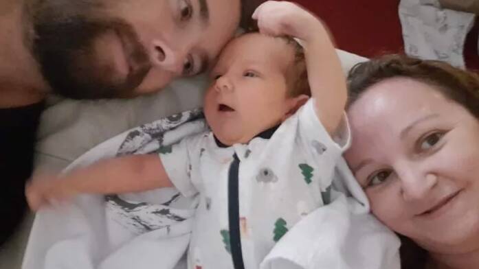 Samuel Hogg and Tessa Pollard with baby Jasper, born in Ukraine and awaiting a passport and travel permits to be allowed to fly home to Australia. Photo: GoFundMe