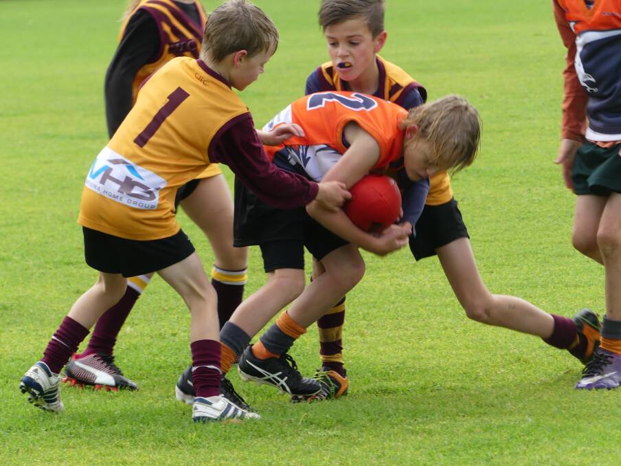 Mitch Kirby and Ethan Semenow lay a tackle in the U9s game against Falcons.