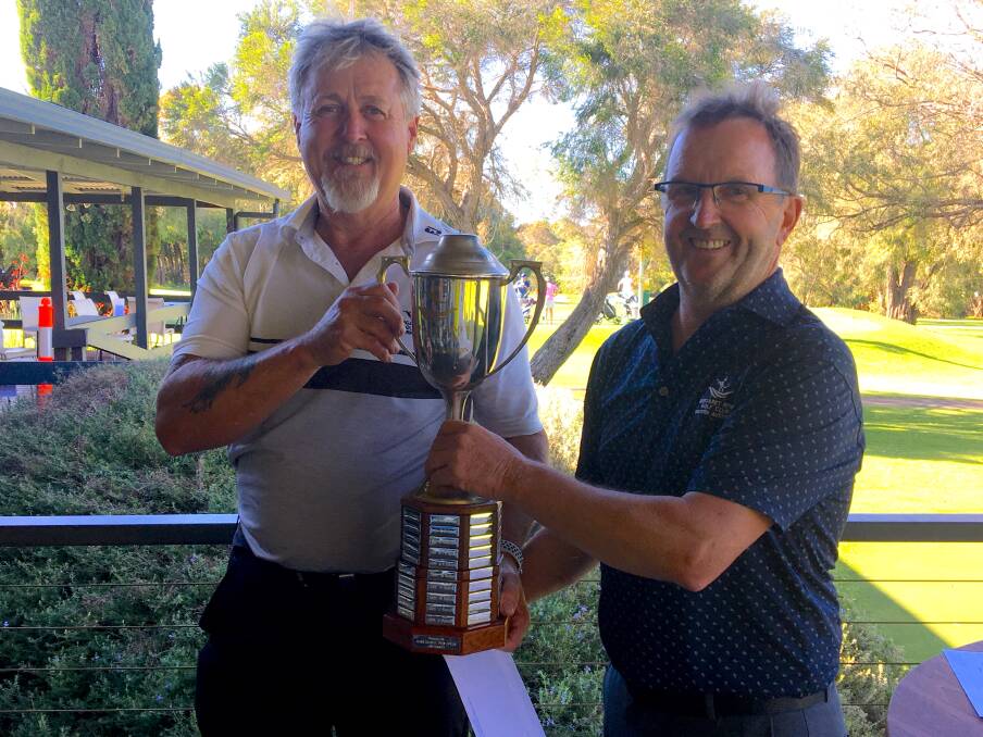 Brian Seed (left) receives 2020 Club Championship trophy from Club Captain John Bell.