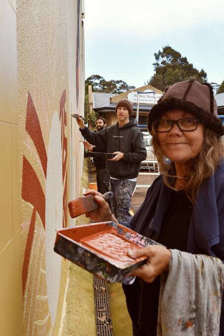 Powerful message: Artists Jack Bromell, Ian Mutch and Sandra Hill put the finishing touches on the Wadandi Boodjarra mural. Photos: Nicky Lefebvre