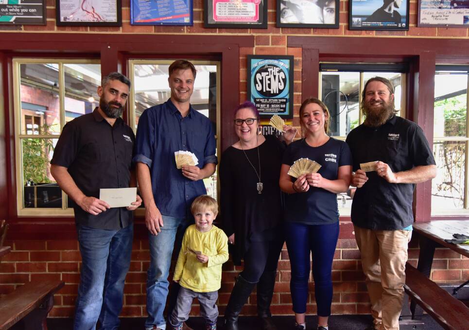 Settlers Tavern Golden Ticket winner Tom Dowling (second from left) with son Sunny and Settlers Tavern and AMR Mail staff. Photo: Lauren Trickett Photography