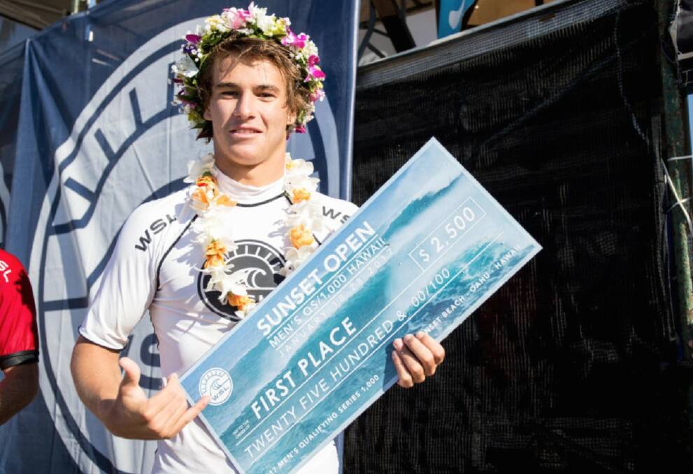 Hero in the making: Jack Robinson claims his prize for finishing third in Hawaii at the Vans Pro. Photo: WSL. 