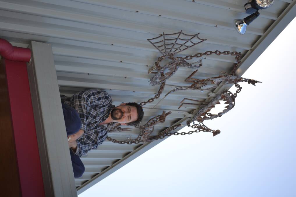 FROM SCRAP TO ART: Justin Webb with one of his creative metal sculptures in the LIA.