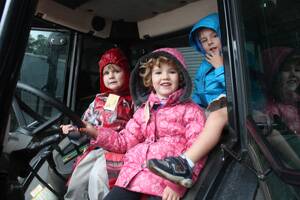 FARMER KIDS: Toby, Minkai and Pepper sit high in the tractor.