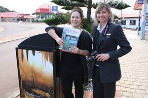 CALLING HAPPY SNAPPERS: Sonja Bernhagen, the barista at Augusta’s Deckchair café and Katrina Smart, a keen photographer from the Bendigo Bank, show off the books that are prizes for the first 10 entrants in the annual photographic competition.