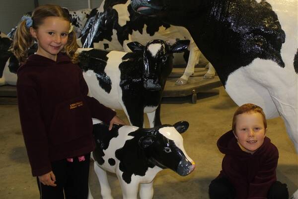 COWARAMUP ON THE MOOVE: Bridie Monger, 5, and brother Aden, 7, with some of the fibreglass cows. Their mother, volunteer Anthea Monger, believes tourists will stop for photos once the cows are placed around the town.