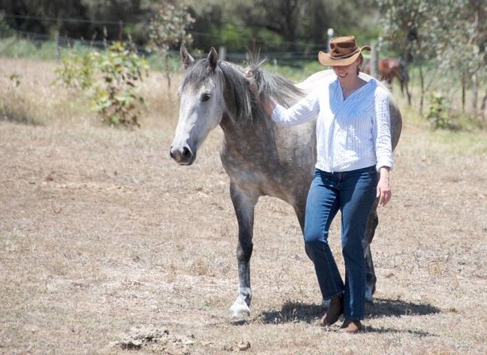 FRIENDS: Elizabeth Denniss, Outback Heritage Horse Association of WA Inc vice president, leads a horse. Picture: Katherine Waddingto