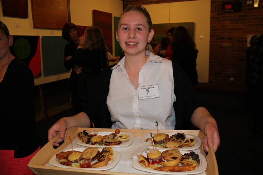 TASTY TREATS: Naomi Eggeling, year 11, hands out food prepared by students.